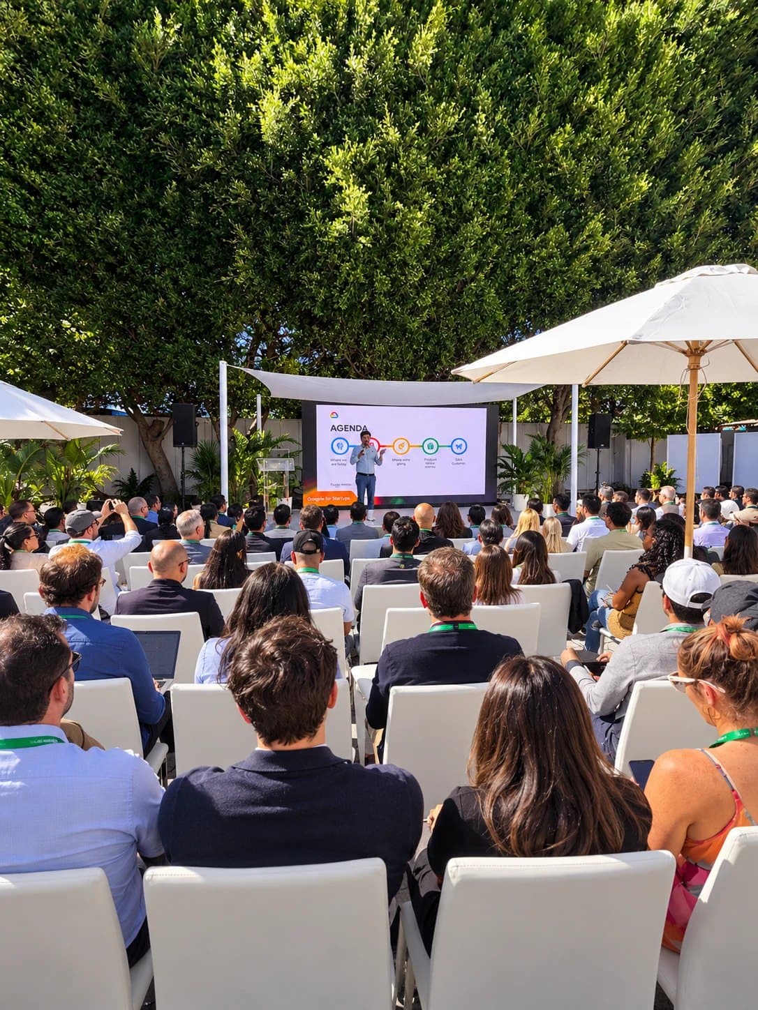 Founders seated under umbrellas at Google Tech Day during LA Tech Week, watching the opening agenda session