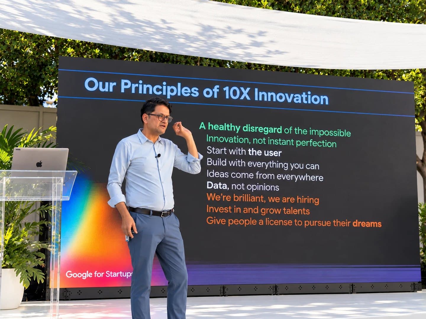 Uday Ghatikar of Google Cloud presenting Google's principles of 10x innovation on an outdoor stage at Google Tech Day