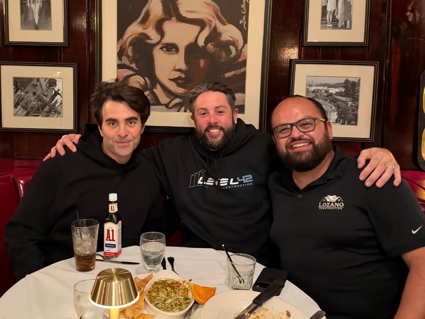 Nicholas Jarecki, Matt Russell and Jorge Lozano at a booth at the Smoke House in Burbank